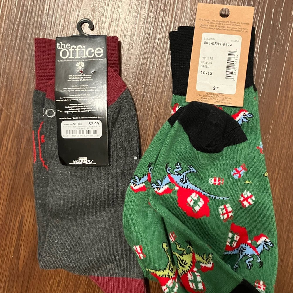Two pairs of socks one Christmas dinosaur & the other is The Office theme